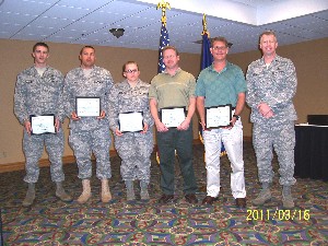 Award winners posing in March are (l-r): 2nd Lt. Chad Maurice, USAF; Master Sgt. Zephaniah Craft, USAF; Staff Sgt. Meghan Williams, USAF; Jeff Gay; Jeff Jennings pose with presenter Col. Bruhl.
